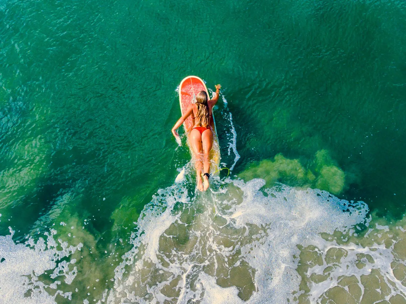 Surfer paddling out