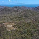 This large lot with no building restrictions and an ocean view has been cleared and fenced.