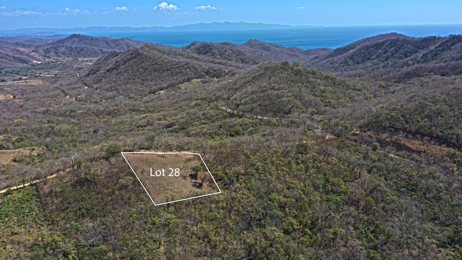 This large lot with no building restrictions and an ocean view has been cleared and fenced.