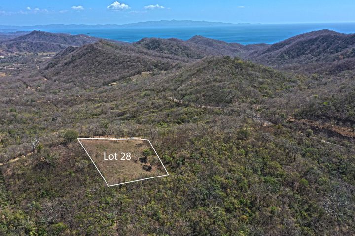 This large lot with no building restrictions and an ocean view has been cleared and fenced.