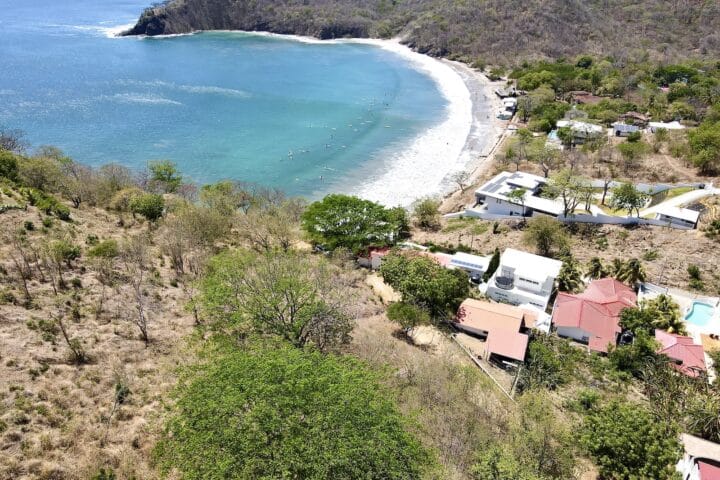 Surfers in the water at Playa Remanso