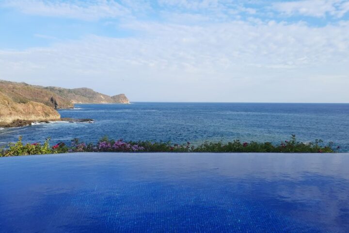 Infinity pool overlooking the Pacific Ocean and coastal cliffs at Guacalito de la Isla, Tola, Nicaragua.