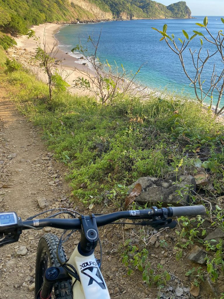 A mountain bike on a coastal trail with ocean views in Tola, Nicaragua.