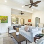 Bright living room with a white sofa and ceiling fan