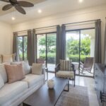 Living area with sliding glass doors opening to greenery