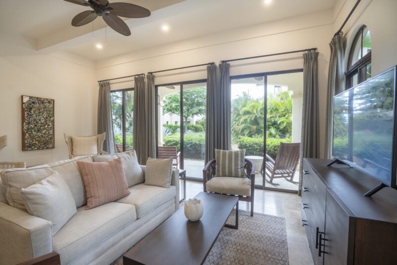 Living area with sliding glass doors opening to greenery