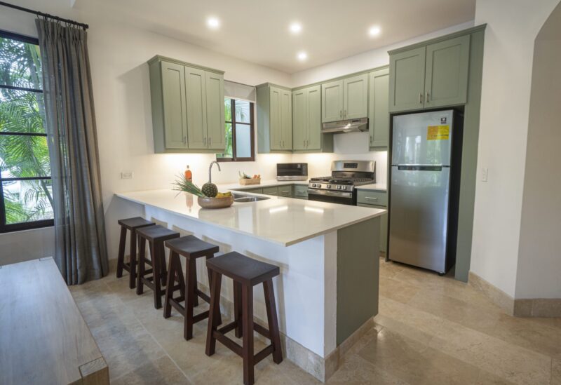 Kitchen with sage-green cabinetry and a center island