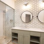 Bathroom with a double vanity and patterned tile