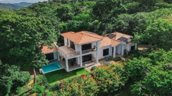 Luxury Oceanview Retreat Modern hillside villa with pool and solar panels nestled in lush greenery, Rancho Santana.