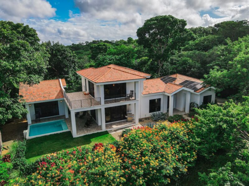 Aerial view of a Luxury Oceanview Retreat in Rancho Santana modern villa with private pool and balcony surrounded by lush tropical forest.