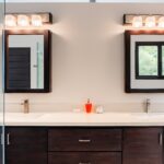Double-sink bathroom vanity with dark wood cabinets, mirrors, and modern lighting in Rancho Santana.