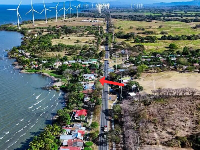 Aerial view of panamerican road, arrow marker, and wind turbines.