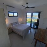 bedroom with ceiling fan and air conditioning in Panoramic Bay View Home