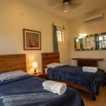 bedroom with two single beds in Playa Maderas Cliff-Front Estate