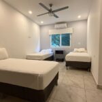 three singles bed bedroom with air conditioning and ceiling fan in Turnkey Bay View Condo