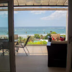 Living room opening to the patio and bay view