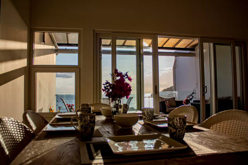 Dining area with afternoon light at the oceanview rental-ready condo