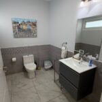 half bathroom with a mirror and sink in Turnkey Bay View Condo