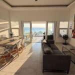 The oceanview rental-ready condo's living and dining area