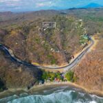 Aerial drone view of the jungle hillside above the coast