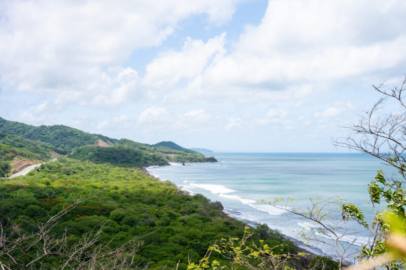 Coastal land with a road leading toward the beach