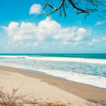 Wide open sand and surf along the shoreline