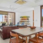 Open-plan living and dining area opening to the pool and surf break
