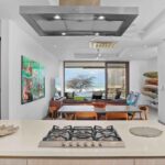 Kitchen island with ocean views and a surfboard rack at this Hacienda Iguana condo