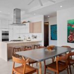 Dining area with ocean-themed artwork inside this Hacienda Iguana condo