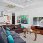 Living room with leather seating and a large flat-screen TV