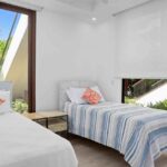 Guest bedroom with two beds at this beachfront condo