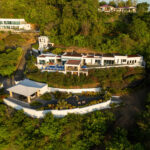 Aerial view of the white multi-level villa perched above San Juan del Sur Bay