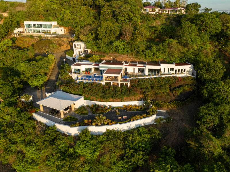 Aerial view of the white multi-level villa perched above San Juan del Sur Bay
