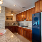 Kitchen with rich hardwood cabinetry and stainless appliances