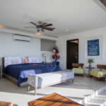 Guest bedroom with a sitting area and blue accents