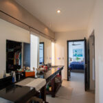 Hallway leading past a built-in desk to a bedroom