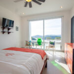 Bedroom with a work desk and an ocean view