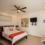 Guest bedroom at the Pacific Marlin Estate with a wall-mounted TV