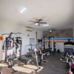 Air-conditioned home gym with cardio and weight equipment