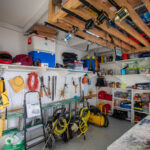 Storage room with surfboards, tools, and outdoor gear
