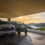 Covered carport at sunset with the included pickup and utility vehicle
