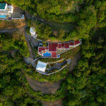Daytime aerial of the villa and grounds on the hillside