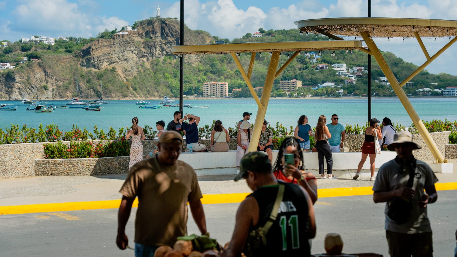 Residents and visitors along the San Juan del Sur beachfront promenade