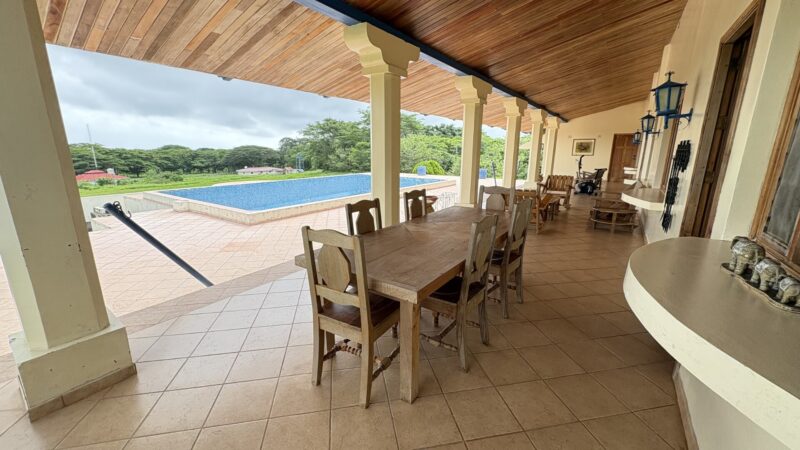 Covered poolside terrace overlooking the grounds