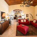 Den with red sofas and arched openings