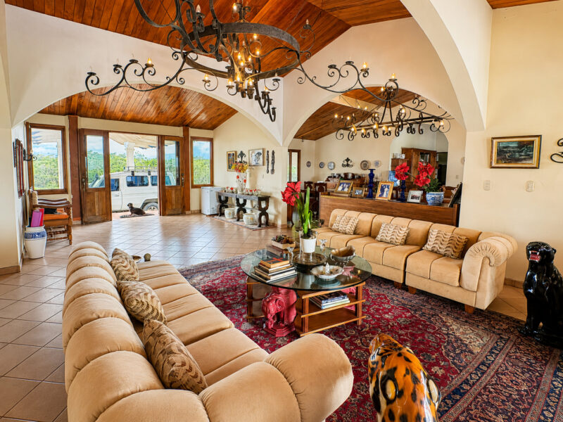 Living room with arched windows and tile floors