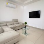 Living room with a sectional sofa and air conditioning