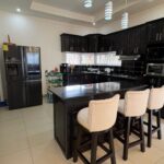 Kitchen with dark cabinetry and a breakfast bar