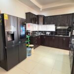 Kitchen with a full-size refrigerator and counters