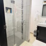 Full bathroom with a glass shower and vanity